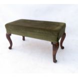 A rectangular window seat, raised on rosewood cabriole legs with carved knees and knurled feet,