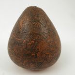 An ornately decorated South American seed pod, possibly Peruvian, height 3.