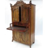 A 19th century mahogany Secretaire a Abattant, having two oval panel doors over a secret drawer,