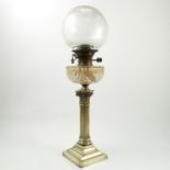 An oil lamp, with glass bowl and reservoir with a corinthian column raised on a square stepped base,