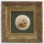A framed circular porcelain plaque, hand painted with Highland cattle in landscape by M Holloway,