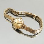 A Tissot ladies 9 carat gold bracelet watch, weight 11.