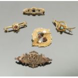 A collection of thirteen brooches, including a shell cameo brooch, a 9 carat gold sapphire brooch,