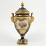 A Coalport porcelain covered pedestal vase, decorated with a deep blue ground and gilt,