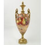 A Fenton China vase, decorated all around with fruit, by Bowkett, raised on a base, badly cracked,