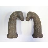 A Pair of Early Persian? Cast Iron Sword Handle Blanks? moulded as horses heads with stylised floral