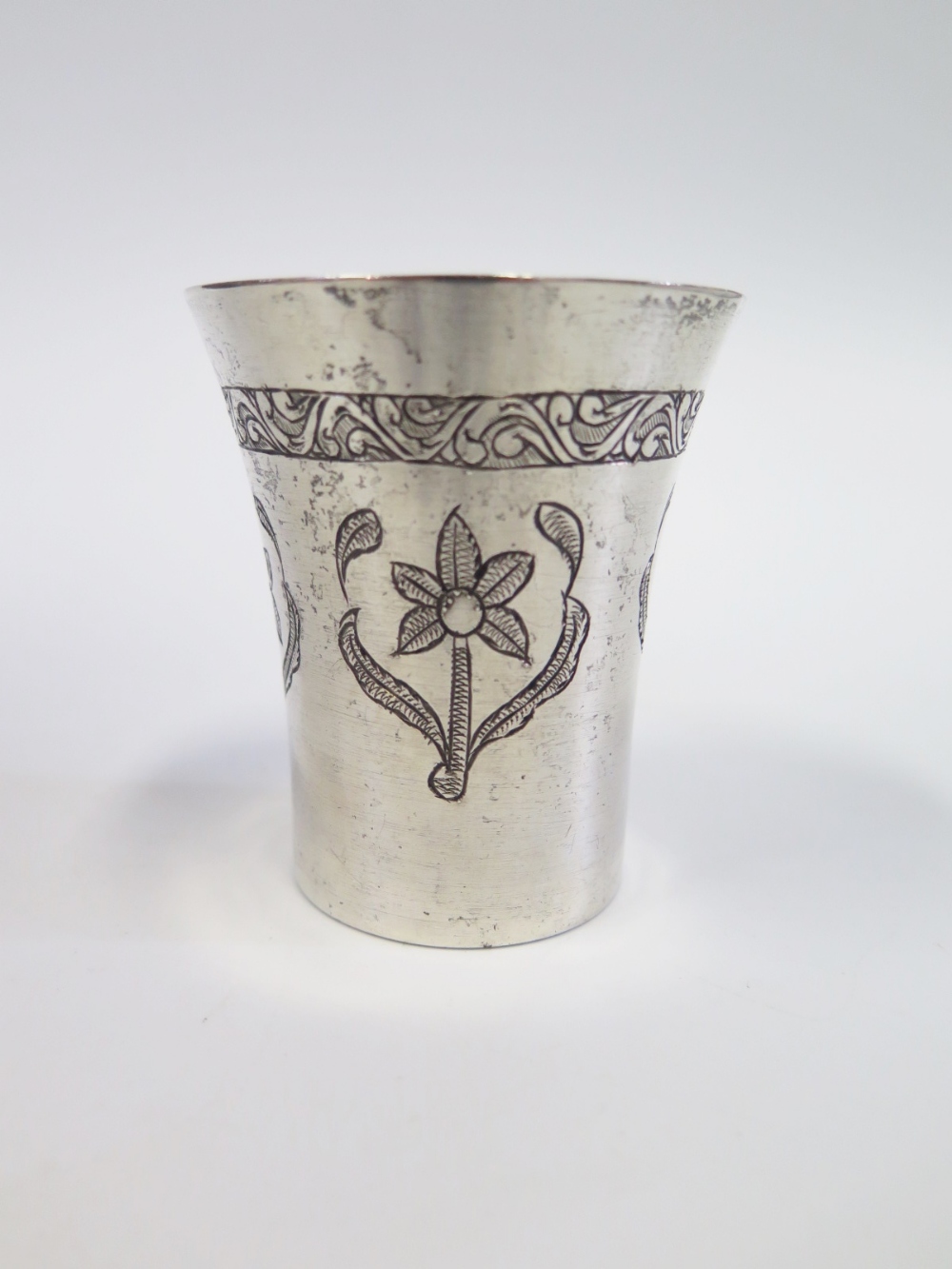 A Persian White Metal Silver Beaker with chased foliate decoration, 8cm, 97g (split to rim)
