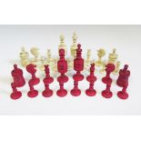 A Nineteenth Century English Carved Bone Chess Set, one side stained red and the other natural, King