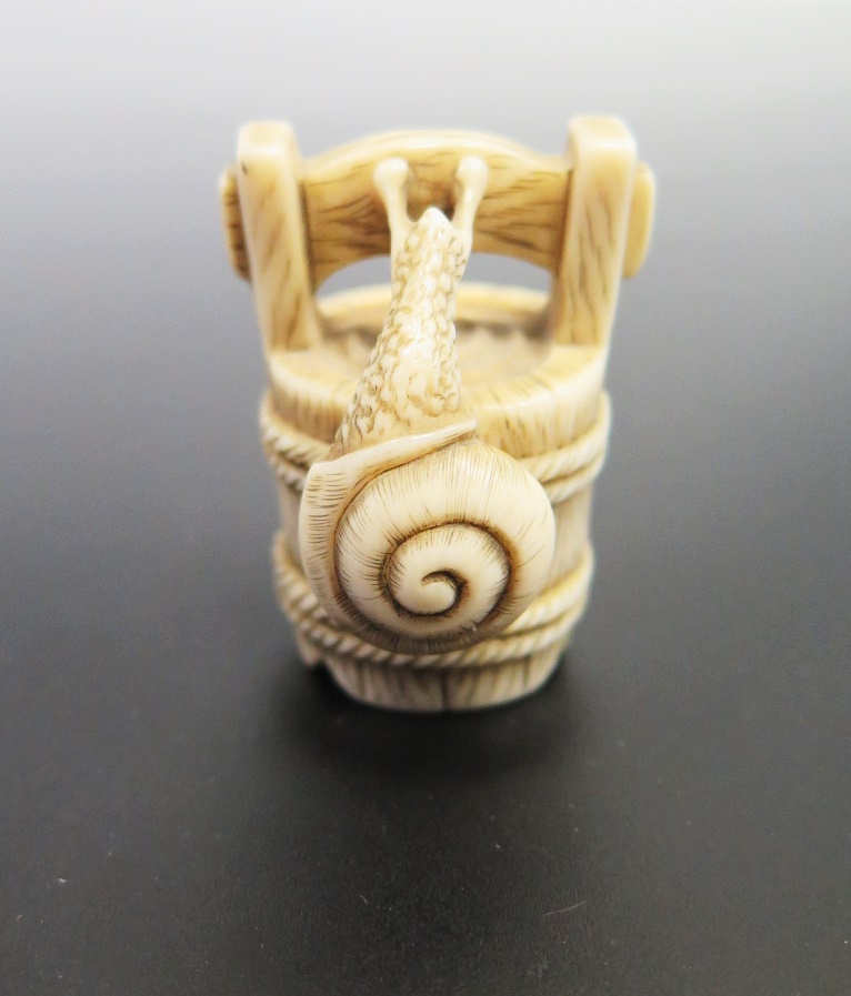 A Japanese Ivory Netsuke carved in the form of a snail climbing a bucket, signed to the base, c. - Image 4 of 4