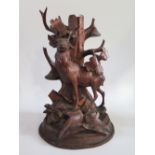 A Black Forest Carved Lamp in the form a a deer standing before an oak tree, 30cm, faults