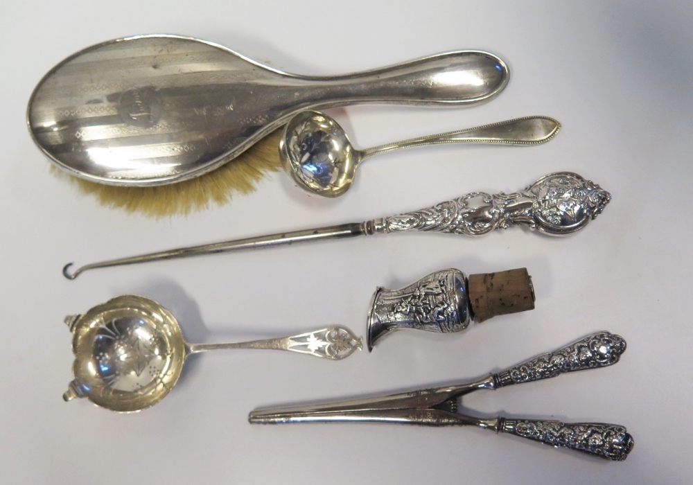 A Silver Tea Strainer, silver glove stretchers and button hook etc