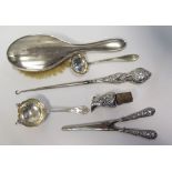 A Silver Tea Strainer, silver glove stretchers and button hook etc