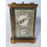 A French Brass Repeating Carriage Clock with enamelled dial and porcelain panels decorated with