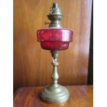 A Victorian Cranberry Glass and Brass Paraffin Lamp, 39cm