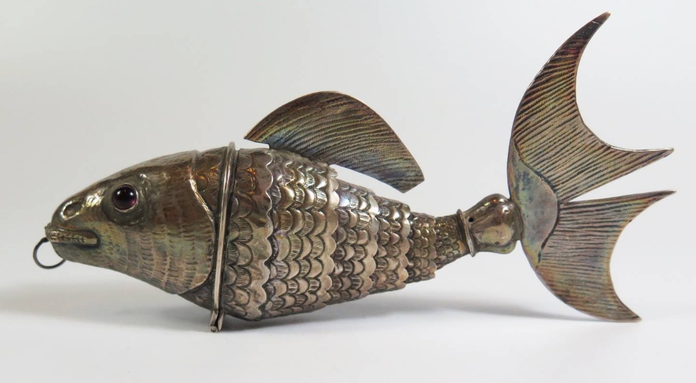 A Continental Silver Articulated Fish with hinged head and amethyst coloured inset eyes, 18cm, 95g