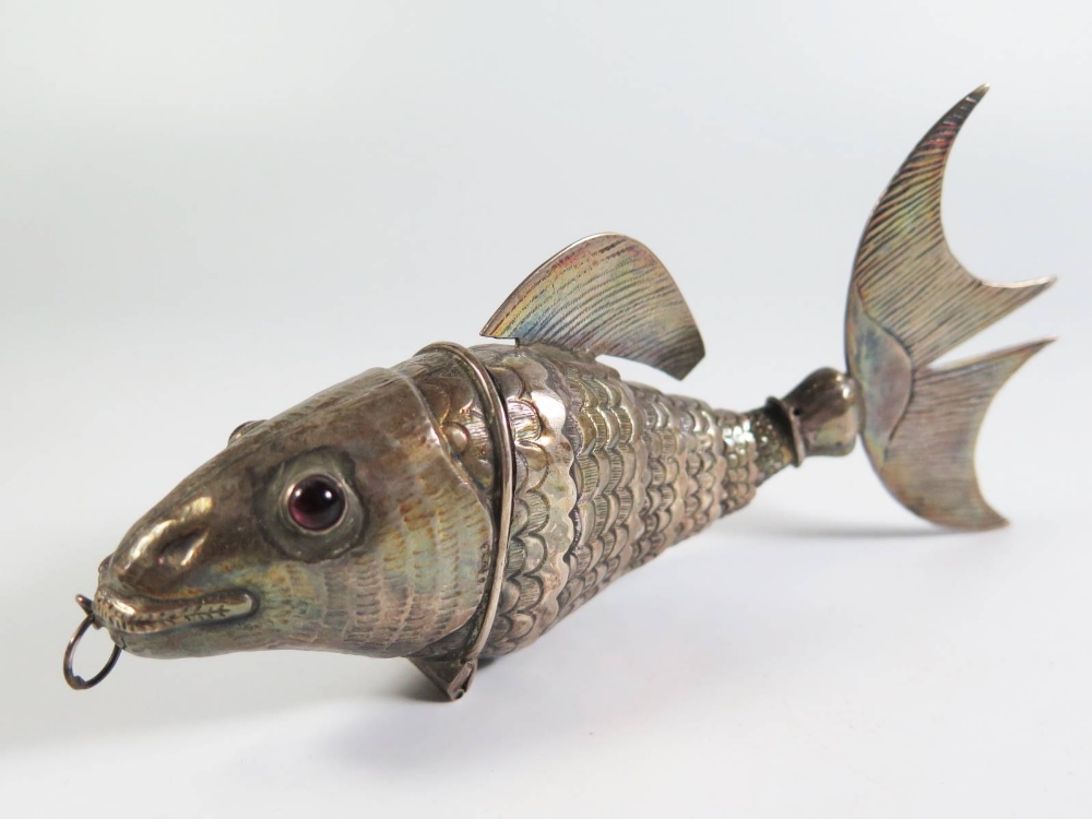 A Continental Silver Articulated Fish with hinged head and amethyst coloured inset eyes, 18cm, 95g - Image 2 of 2