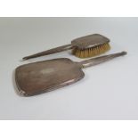 A Silver Backed Hand Mirror and Brush