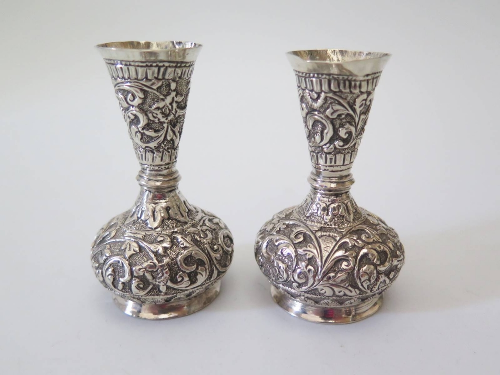 A Small Pair of Indian Silver Vases decorated with scrolling foliate work, 7.5cm