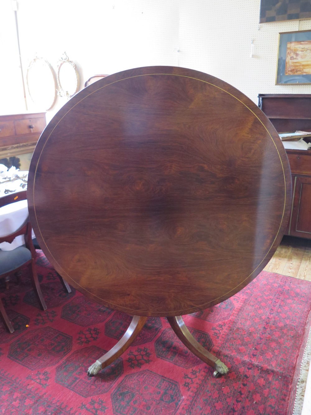 A Nineteenth Century Rosewood and Brass Inlaid Circular Pedestal Dining Table on Quadruped Base,