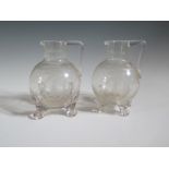 A Pair of Nineteenth Century Engraved Glass Jugs decorated with monogram, 14cm, one damaged