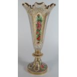 A Bohemian Overlay Glass Vase with diamond cut pattern and flowers painted in enamels and gilt