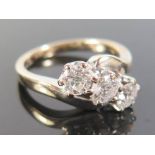 An 18ct White Gold Three Stone Diamond Ring, c. 1ct, size K.5