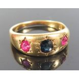 An 18ct Gold Ruby and Sapphire Gypsy Ring, size S.5