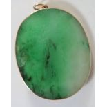 A Chinese Jadeite Pendant / Brooch in yellow metal mount, 43mm