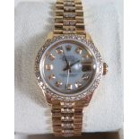 A Rolex Ladies 18K Gold President Oyster Perpetual Datejust with aftermarket set diamonds to the