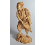 A Japanese Ivory Okimono in the form of a fisherman casting his net, signed to the base, 15.5cm