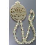 A Carved and Pierced Jade Circular Pendant decorated with flowers on agate bead necklace, 52mm