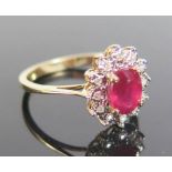 A Ruby and Diamond Ring in 9ct yellow gold setting, size N.5