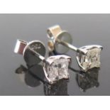 A Pair of Princess Cut Diamond Stud Earrings in 18ct white gold setting, c. 1.25ct