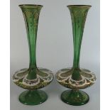 A Pair of Bohemian Green Ground Overlay Glass Vases, slice cut and with flowers painted in enamels