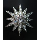 A Diamond Star Brooch, central stone c. .6ct, 39mm diam