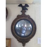 An Early Nineteenth Century Gilt Wood Convex Mirror with eagle pediment, 95cm high