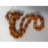 An Amber Bead Necklace, 53.9g