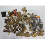 BAG OF MILITARY CAP BADGES ETC AND SMALL BAG OF BUTTONS