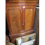 MAHOGANY SERPENTINE CUPBOARD OVER CHEST WITH SLIDE