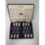 A George V Silver Presentation Cased Set of Twelve Tea Spoons and tongs, Sheffield 1923