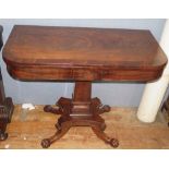 A Nineteenth Century Mahogany Card Table with quadruped base carved with lion paw feet