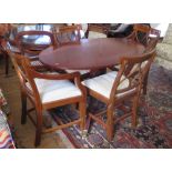 A Small Brights of Nettlebed Regency Style Oval Dining Table with four chairs including two carvers