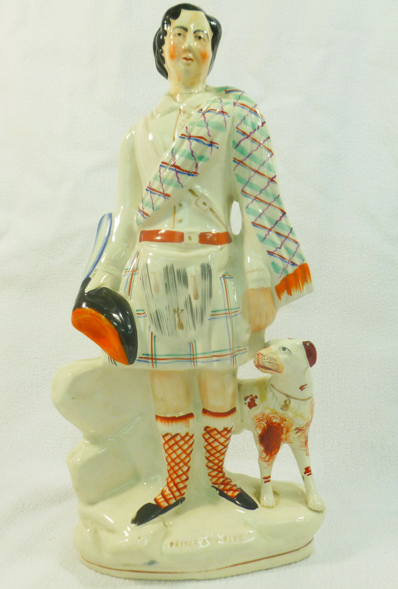 A Victorian Staffordshire pottery flatback figure of the Prince of Wales with a dog,