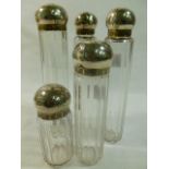 A set of five Victorian facet cut glass dressing table jars with silver dome topped screw on lids