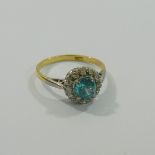 A blue zircon and diamond circular cluster ring,