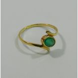 A 14 carat gold emerald single stone cross over ring,