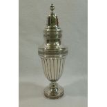 A tall Continental silver Regency style sugar castor with formal embossed and applied cast