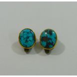 A pair of Victorian oval turquoise cabochons in rub-over gold mounts converted to clip on earrings,