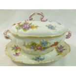 A 19th century Meissen porcelain oval sauce tureen with integral stand, with gilt rims,