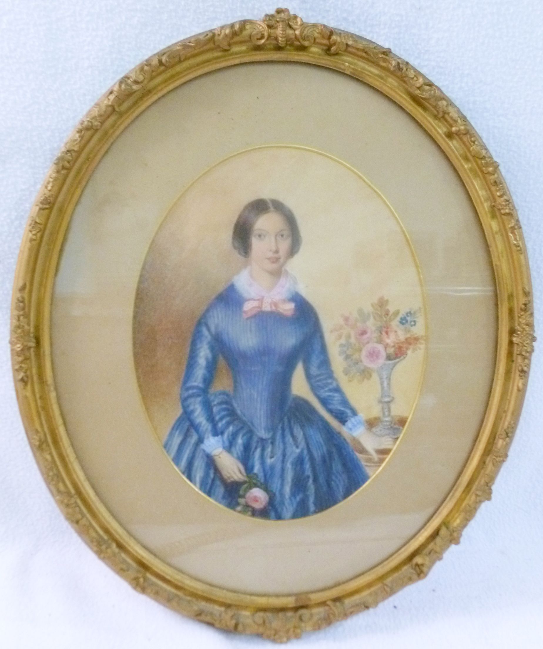 A Victorian watercolour portrait of a young woman in a blue dress beside a vase of flowers, - Image 2 of 2